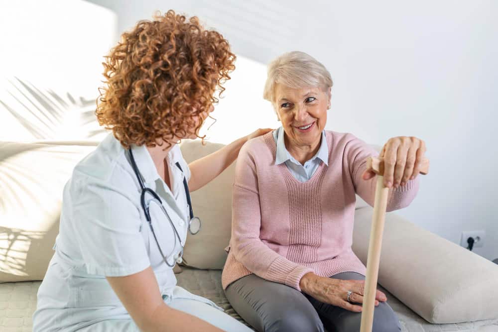 Health care provider warmly interacting with senior female patient